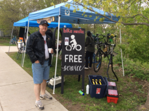 Bill the Bike Medic in Dexter MI standing besides his kiosk